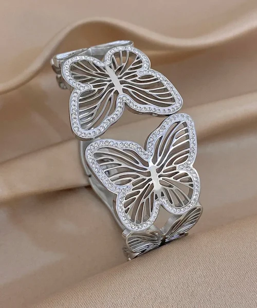 Bracelet papillon ajouré argenté, jonc large à papillons découpés et liseré de zircons