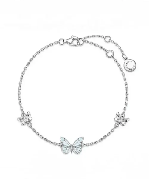 Bracelet papillon phosphorescent argenté, papillon bleu pâle entre deux fleurettes serties