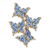 Broche papillon bleu et blanc, quatre papillons en émail façon porcelaine et contour doré