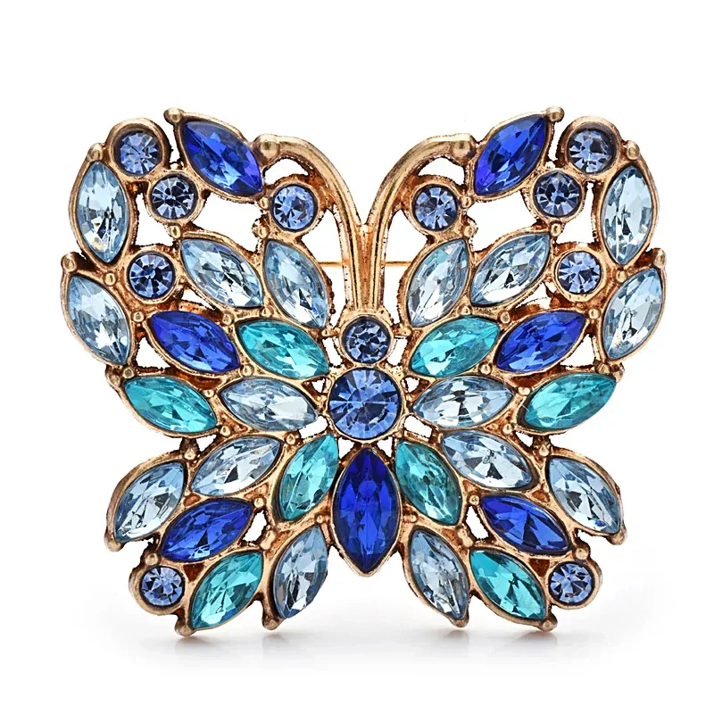 Broche papillon camaïeu bleu, strass navette en rosace sur monture dorée