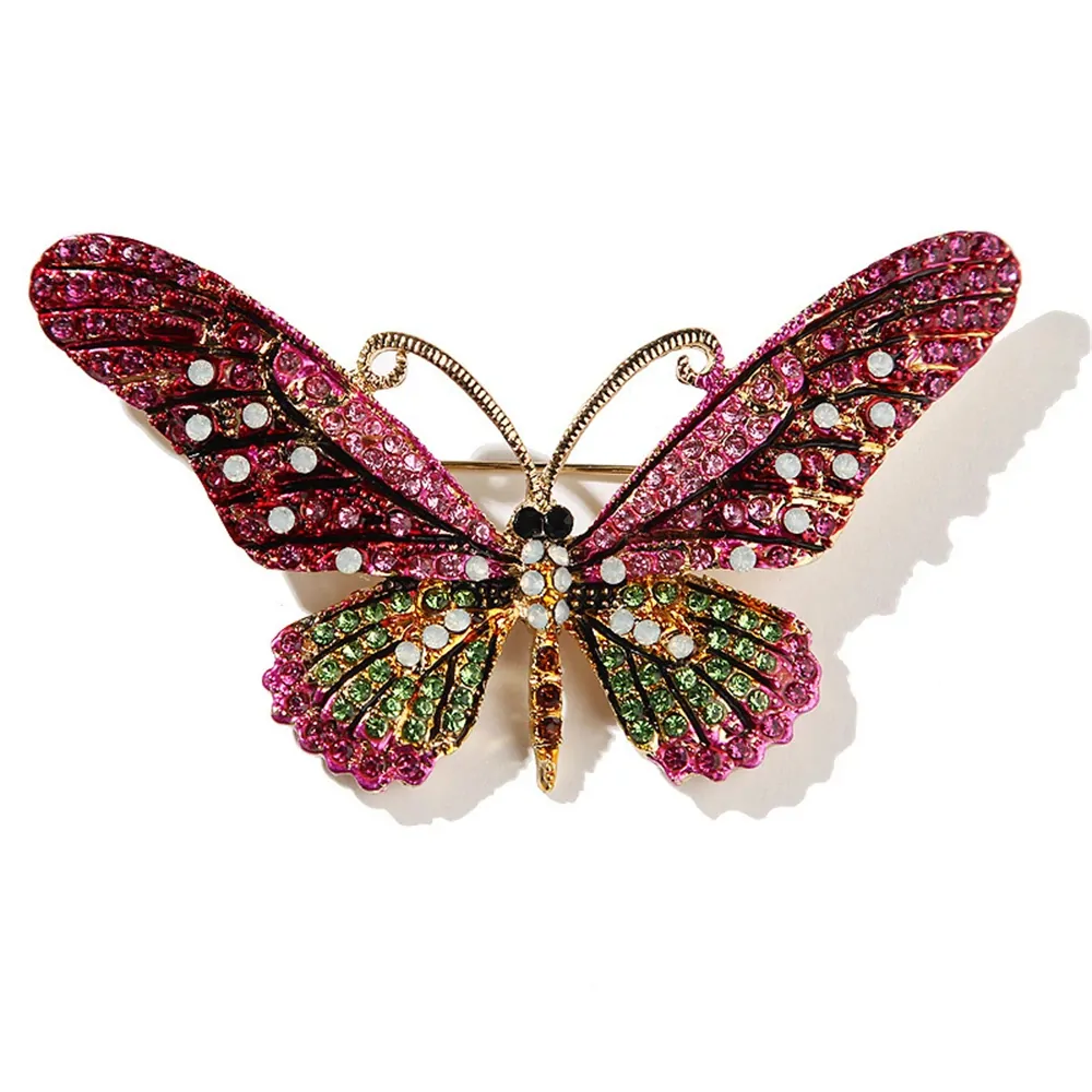 Broche papillon cristal fuchsia, ailes pavées de strass colorés et antennes dorées