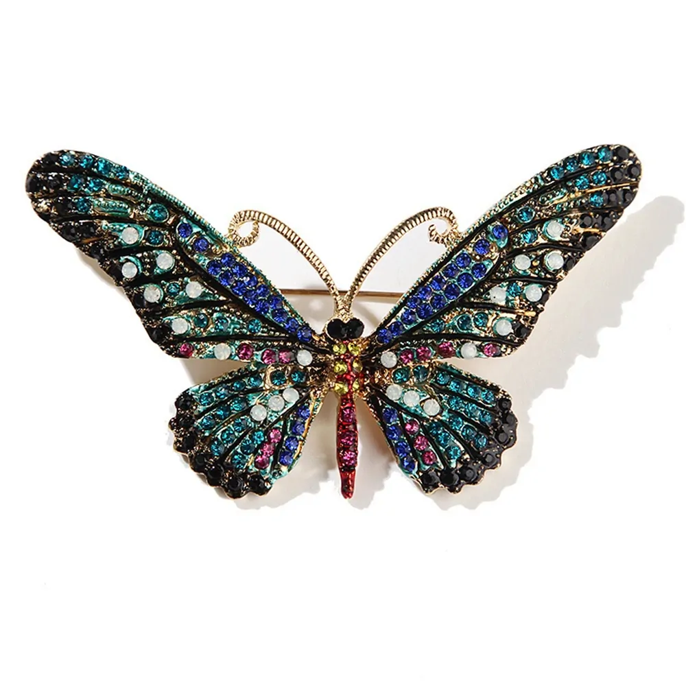 Broche papillon cristal turquoise, ailes pavées de strass colorés et antennes dorées