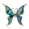 Broche papillon en coquillage naturel irisé bleu et vert, monture argentée