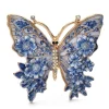 Broche papillon en émail bleu, ailes peintes façon vitrail et fleurs en relief