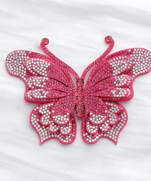 Broche papillon en relief fuchsia, ailes superposées couvertes de strass