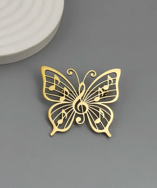 Broche papillon note de musique dorée, clé de sol et notes ajourées en acier inoxydable