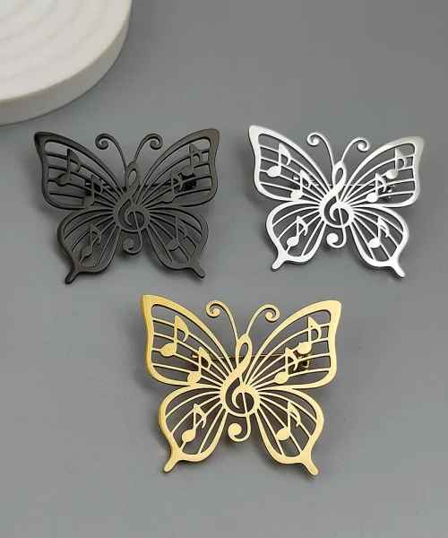Broche papillon note de musique, lot des trois finitions dorée, argentée et noire