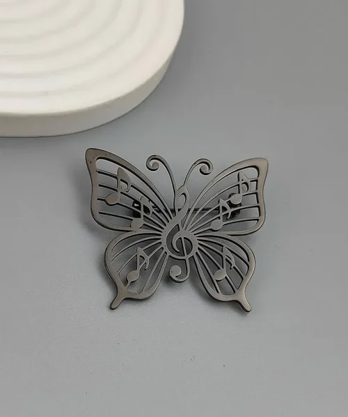 Broche papillon note de musique noire, clé de sol et notes ajourées en acier inoxydable