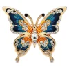 Broche papillon strass bleu et orange, ailes en émail bordées de strass et cristal central