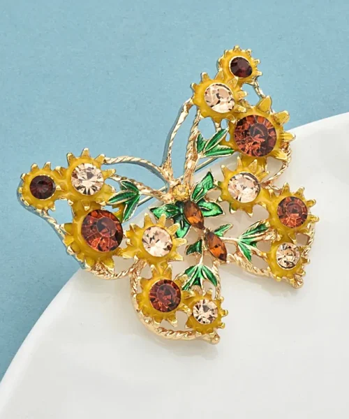 Broche papillon tournesol vue de profil, monture dorée torsadée ajourée