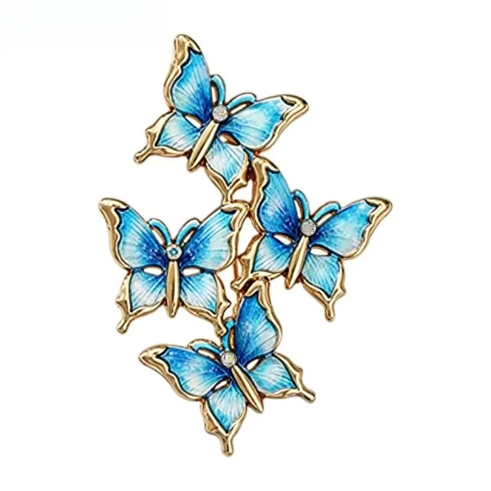 Broche papillons en grappe bleu ciel, quatre papillons en émail et contour doré