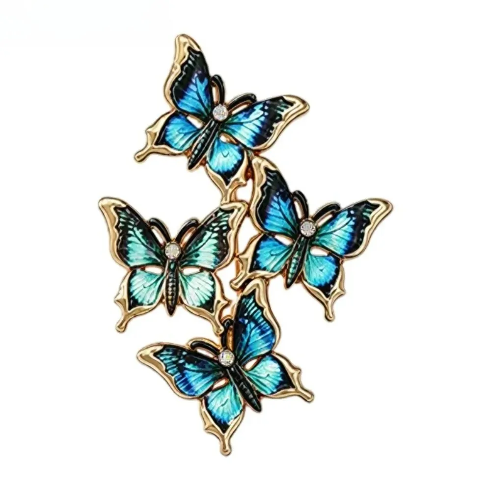 Broche papillons en grappe bleu paon, quatre papillons en émail et contour doré