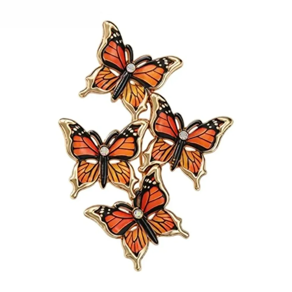 Broche papillons en grappe monarque, quatre papillons en émail et contour doré