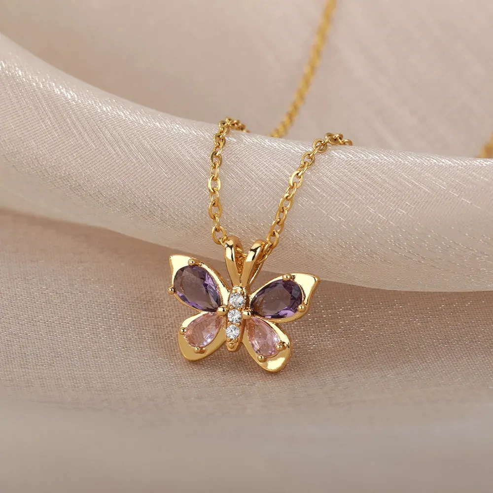 Détail du papillon doré à quatre ailes en cristal violet et rose