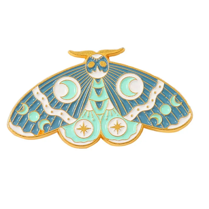 Pin's papillon céleste turquoise en émail, lunes et étoiles dorées