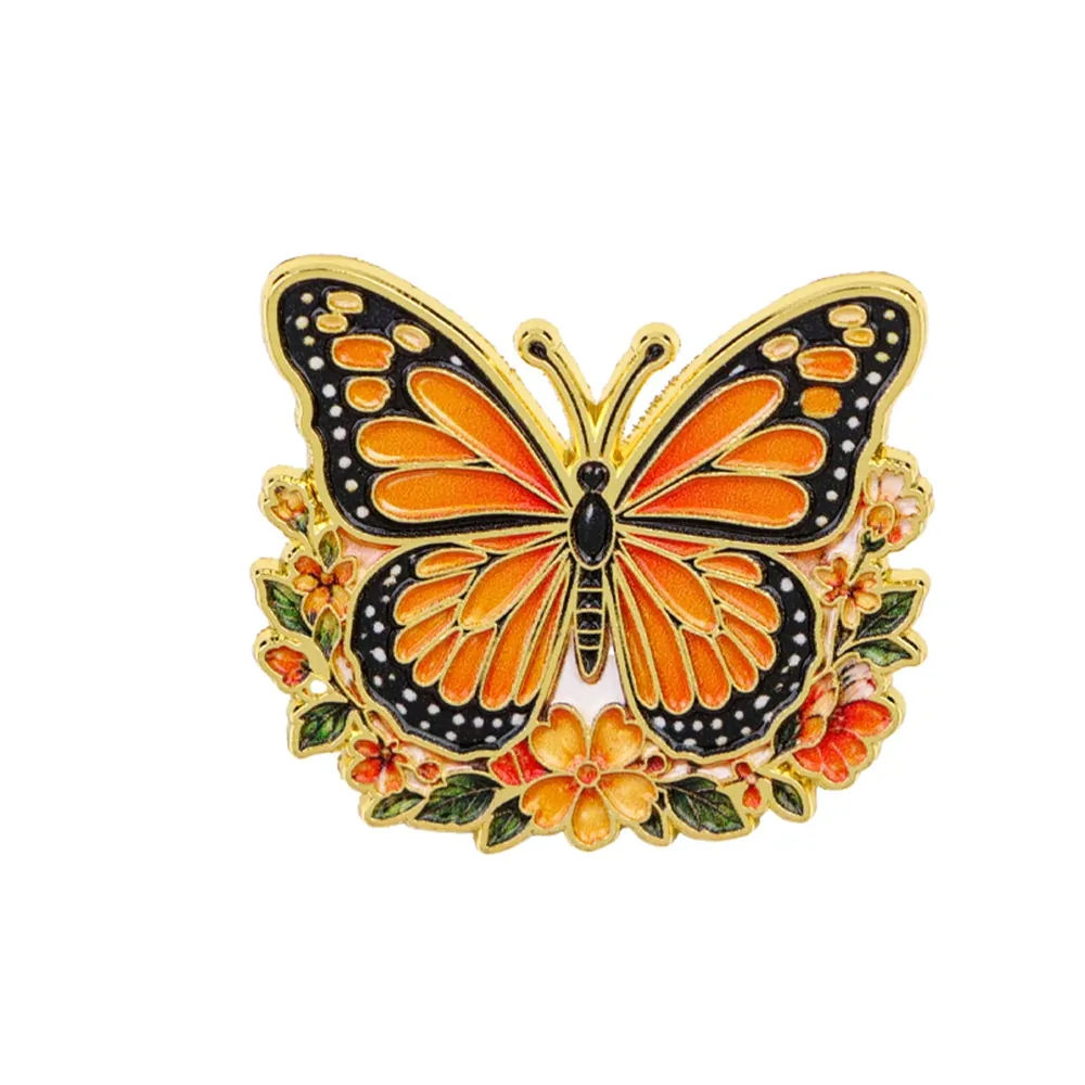 Pin's papillon fleuri monarque, papillon en émail sur couronne de fleurs dorée