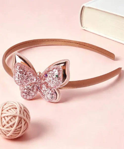 Serre-tête papillon pailleté champagne, arceau satiné et papillon à paillettes semé d'étoiles
