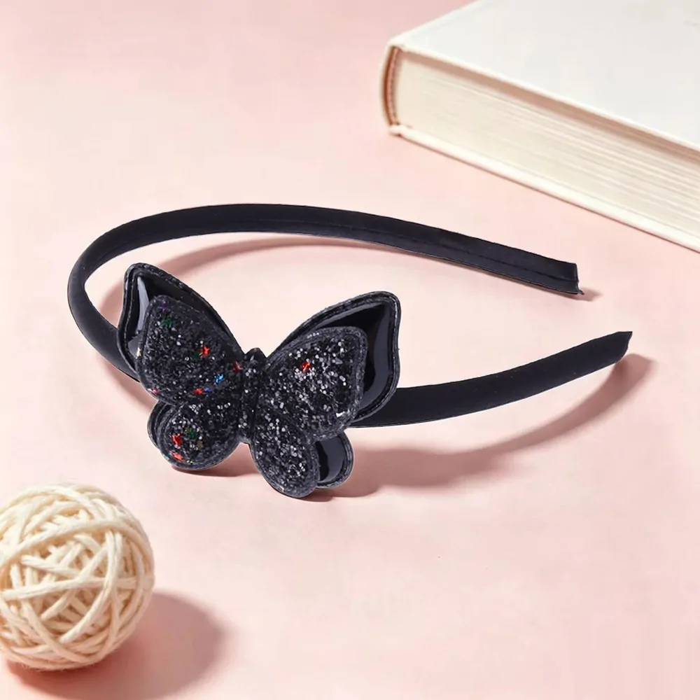 Serre-tête papillon pailleté noir, arceau satiné et papillon à paillettes semé d'étoiles