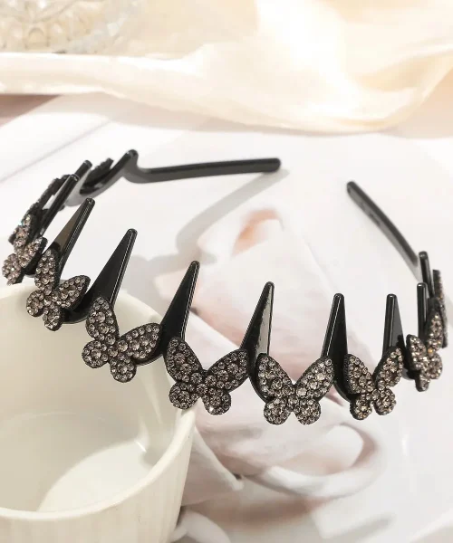 Serre-tête papillon strass gris, arceau ondulé à dents noir couronné de papillons pavés